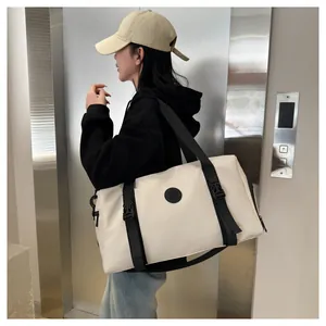 Off-white waterproof travel bag with black straps worn by a model in an elevator