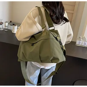 Detail einer großen dunkelgrünen Canvas-Tasche mit verstellbarem Gurt und Seitentasche