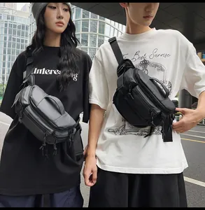 Detail of dual multi-pocket tactical chest bags in black and grey for daily commuting