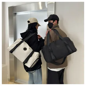 Detail of waterproof nylon gym bags in black and cream white with adjustable straps