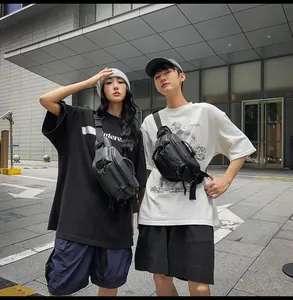 Outdoor street view of couple wearing large capacity black nylon crossbody chest bags
