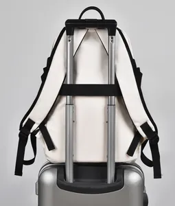 Beige laptop backpack with black trolley sleeve attached to a silver luggage handle