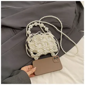 Détail du sac à main en perles fait main avec doublure en satin et bandoulière perle