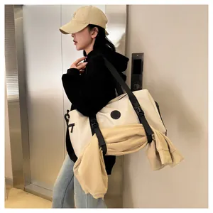 Detail of travel bag with front buckles securing a sweatshirt for extra storage