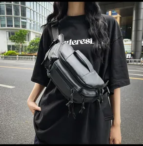 Detail of black tactical crossbody chest bag with multi-zipper layers and wide strap