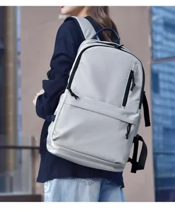 Detailed side view of a large capacity grey water-resistant backpack on a model
