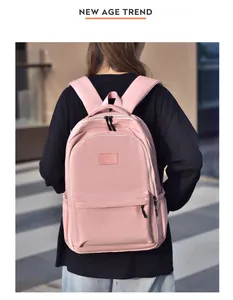 Vue détaillée du dos d'un sac à dos en nylon rose avec plusieurs compartiments et poches