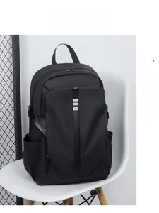 Close-up of a black waterproof casual backpack for men placed on a white designer chair