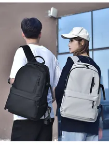 Water-resistant commuter backpacks in black and grey shown by models in an outdoor setting