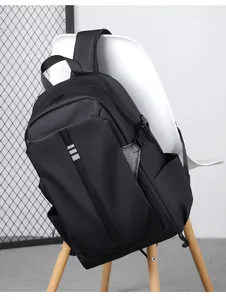 Detail of black water-resistant nylon backpack with silver stripes on a Nordic chair