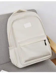 Détail du sac à dos en nylon imperméable crème avec poche zippée et pochette latérale