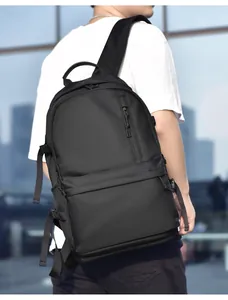 Side view of a minimalist black water-resistant laptop backpack worn by a model