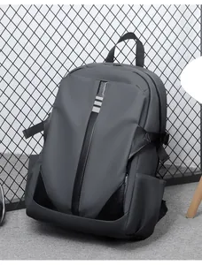 Detail view of water-resistant dark grey backpack with stylish matte finish and black leather trim