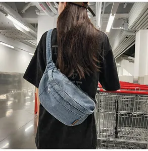 Detail of vintage washed denim crossbody bag featuring textured fabric and leather accents