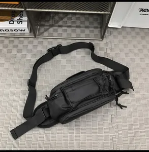 Close-up of tactical black crossbody chest bag with multi-zippered compartments and straps