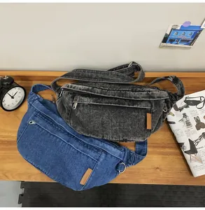 Detail of vintage denim waist bags in black and blue with leather fashion logo tag