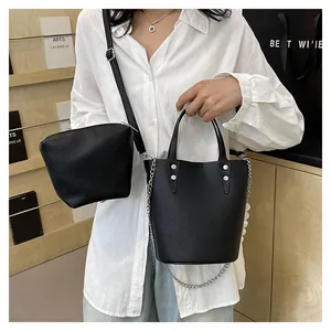 Fashionable black lychee grain leather bucket bag set with silver chain and strap details