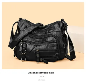 Détail du sac noir en cuir PU texturé avec plusieurs fermetures éclair et anneaux métal