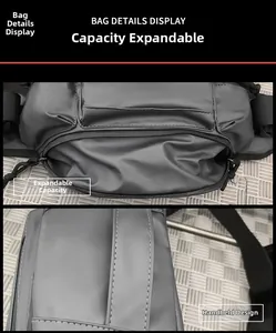 Detail view of dark grey chest bag showing expandable capacity and side handle strap