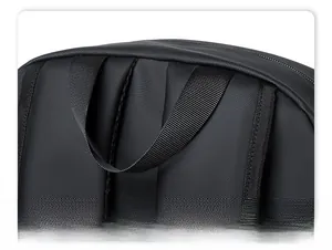 Macro shot of the ergonomic black backpack top handle and reinforced nylon strap stitching