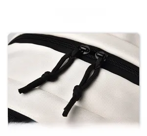 Detail view of smooth dual-way metal zippers on a white water-resistant backpack