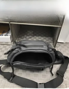 Macro view of the large internal capacity of this black utility crossbody chest bag