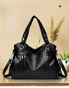 Macro shot of black litchi grain leather texture and metallic zipper on a large tote bag