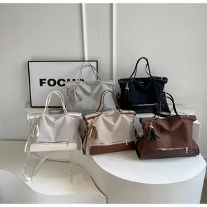 Collection of multi-color canvas tote bags with leather trim and tassel details