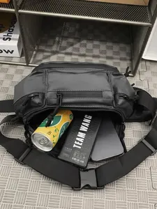 Tactical black crossbody bag showing large storage capacity for phone and power bank