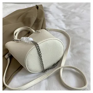 Detailed top view of lychee grain bucket bag with silver chains and beaded decoration
