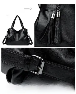Detailed macro view of black faux leather tote with silver hardware and tassel charms