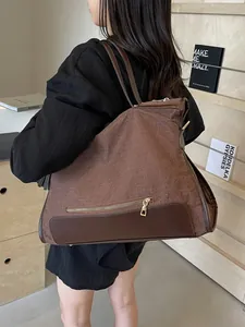 Large brown canvas tote bag with woven texture and contrast leather trim for daily commute