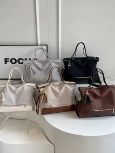 Large canvas tote bags in five colors with contrast leather trim for summer commute