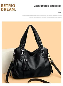 Detail of black lychee texture PU leather tote bag with silver hardware and fringe tassel