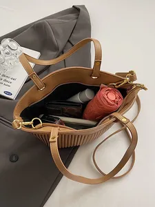 Large caramel pleated tote bag for women showing spacious interior with dual handles