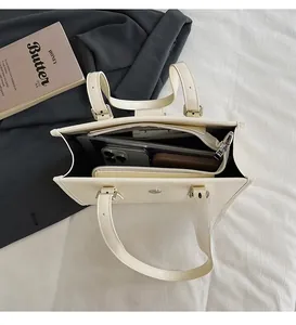 Interior detail of creamy white leather tote bag showing large capacity for tablet and phone