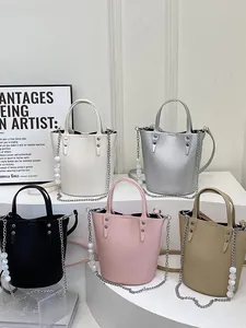 Litchi pattern bucket bags in four colors with pearl chain and metal rivet details