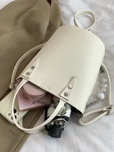 Minimalist beige bucket bag with silver chain and bead strap showing large capacity
