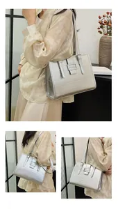 Detail of silver metallic tote bag featuring fine horizontal textures and square buckle clasp