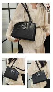 Close-up of black crocodile pattern leather tote bag featuring a silver square buckle