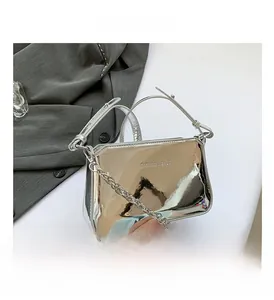 Detail view of silver mirror leather bag with metal chain and fashion bag logo