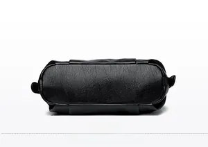 Detailed base view of black leather tote bag showing textured grain and stitched seams