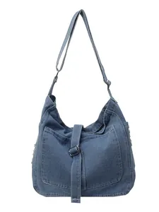 Retro washed denim hobo bag featuring large front pocket and adjustable shoulder strap