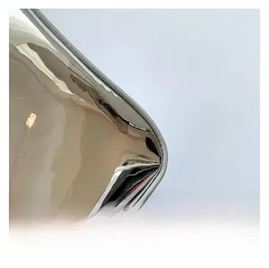 Detail shot of the shiny silver metallic mirror fabric with grey piping on the handbag