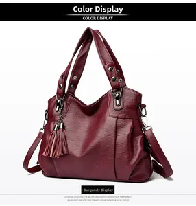 Detail of wine red tote bag with lychee texture faux leather and matching tassel