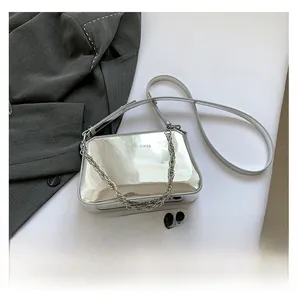 Macro view of silver mirror finish shoulder bag with thick chain and fashion text