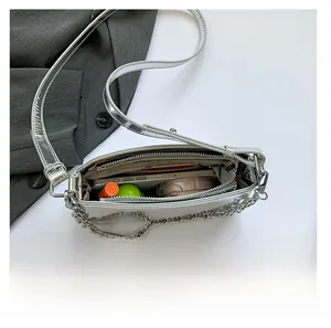 Top view of silver metallic bag interior showing capacity for phone and cosmetics