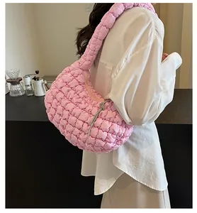 Pink quilted cloud bag with sparkling crystal knot zipper detail on a casual shoulder bag