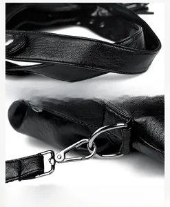 Detailed view of black leather tote bag featuring reinforced stitching and silver hardware