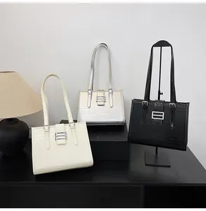 Detailed comparison of three large tote bags in cream, silver, and crocodile black leather